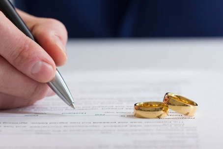 person writing next to two rings
