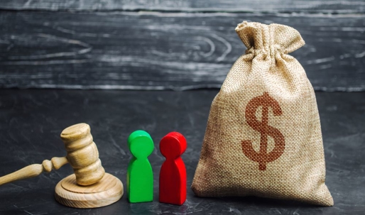 money bag, gavel, two wooden figures