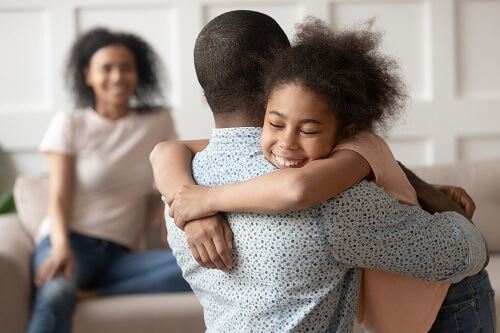 daughter hugging her father